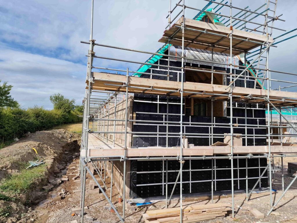 House under construction with scaffolding around it