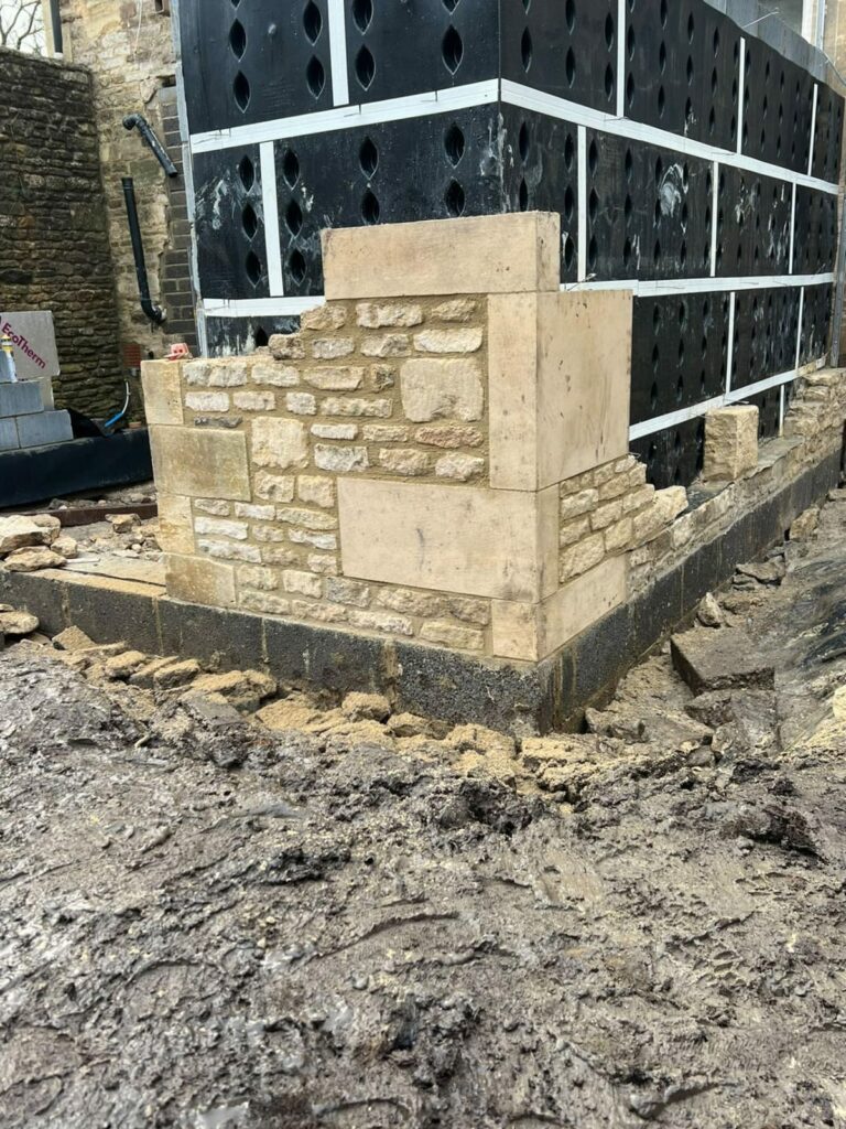 Stone wall under construction with SureCav installed