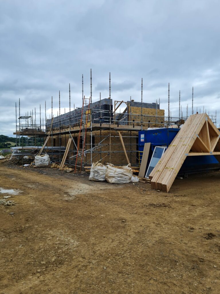 Stone built home, under construction using the SureCav cavity spacer, rainscreen BBA approved system