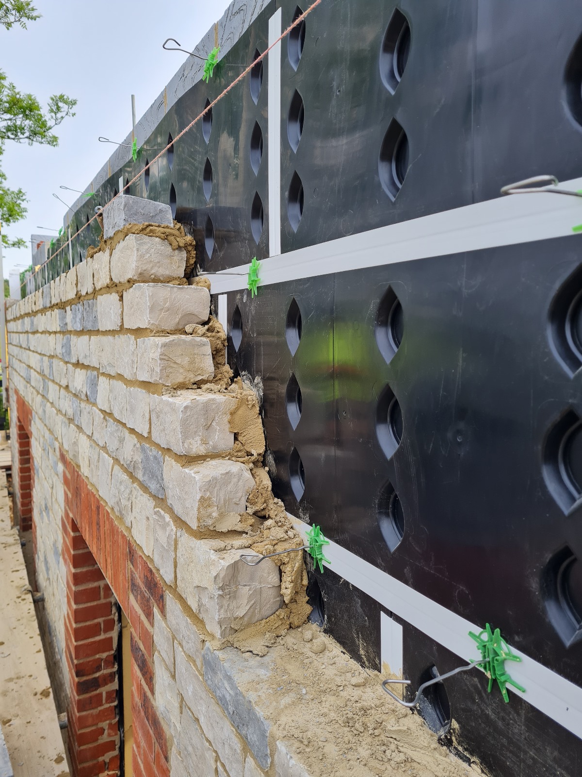 Masonry construction, against the SureCav BBA approved, cavity spacer, rainscreen system used with a partial fill insulation cavity. construction, against the SureCav BBA approved, cavity spacer, rainscreen system used with a partial fill insulation cavity.